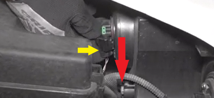 push in tab and pull down harness to release harness